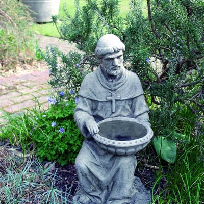 St Francis of Assisi Bird Feeder Stone Statue beside water