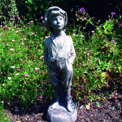 Whistling Urchin Garden Statue in garden setting