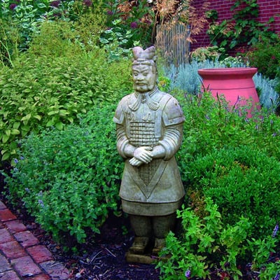 Terracotta Warrior Statue positioned in a garden border