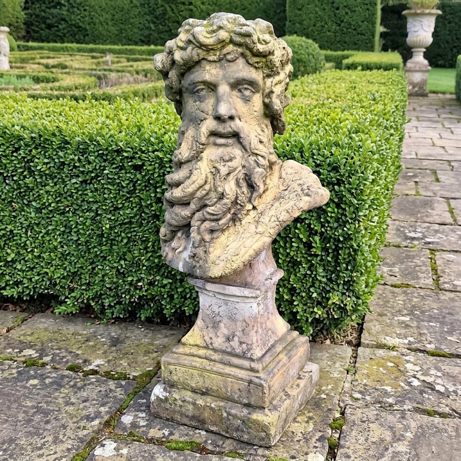 Hercules bust garden statue on a tall stone plinth in a formal UK garden, illustrating correct eye-line height